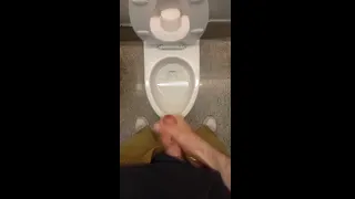 A horny guy quickly jerks off in an airport toilet