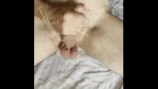 Cock stroking whore masturbates out a creamy load of cum