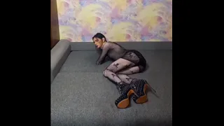 Sissy slut poses in a fishnet outfit